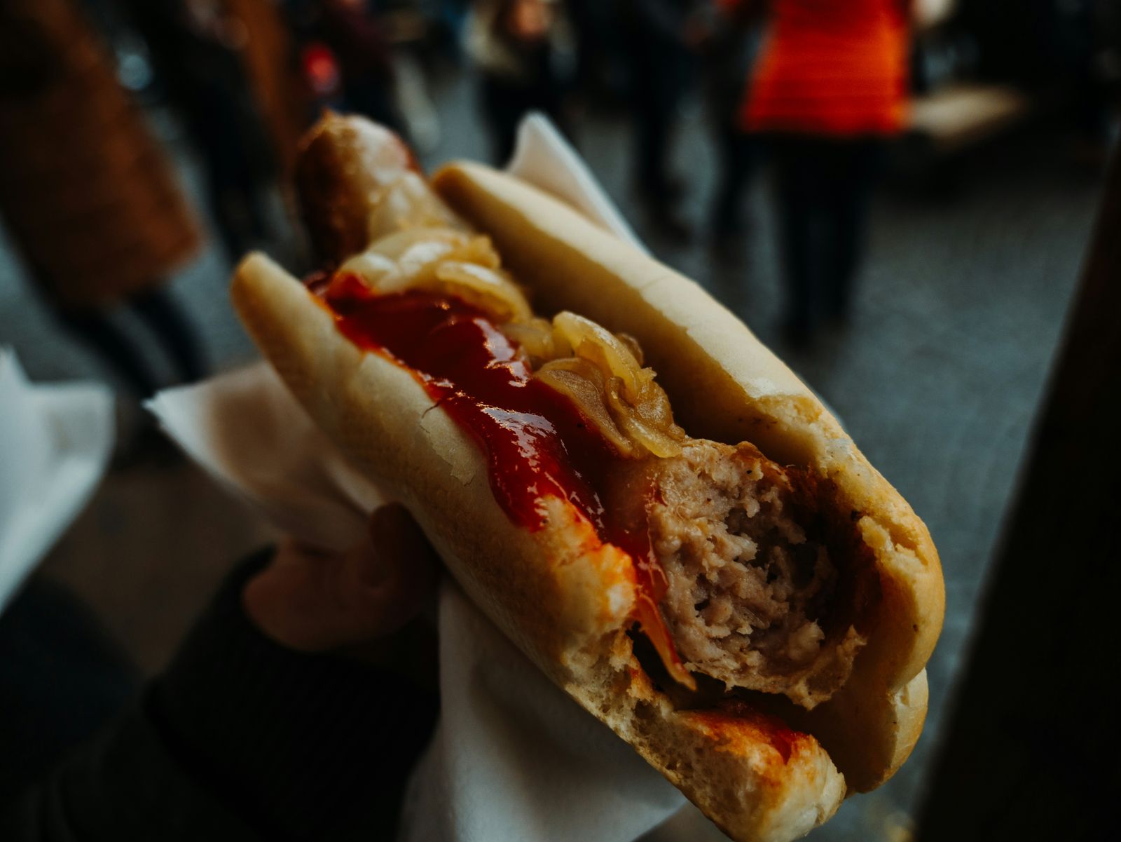 Brats with peppers and onions in buns
